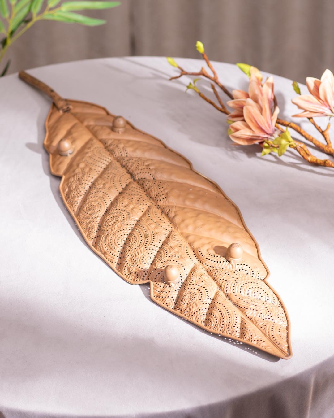 Metal leaf serving platter with gilded finish rear side with stand.