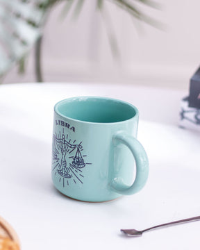 Side view of a Libra-themed turquoise mug, perfect for those who enjoy horoscope-inspired kitchenware.