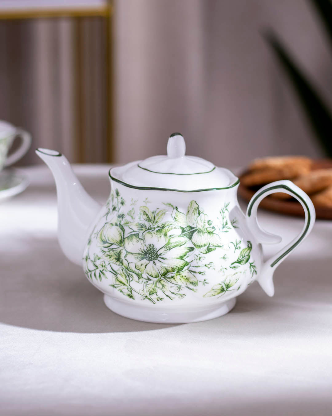 Timeless Devonshire Floral Ceramic Kettle with a luxurious green finish and delicate flower illustrations, side view.