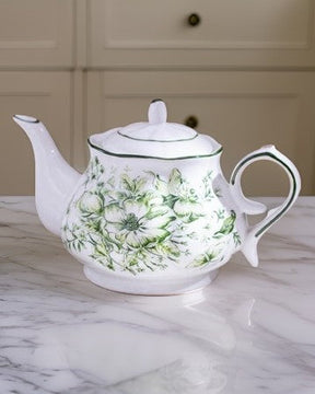 Devonshire Floral Tea Kettle featuring elegant emerald ceramic with overglaze finish and traditional floral patterns on kitchen marble countertop.