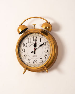 Elegant rustic gold wall clock with a traditional face and ornate hands for sophisticated style.