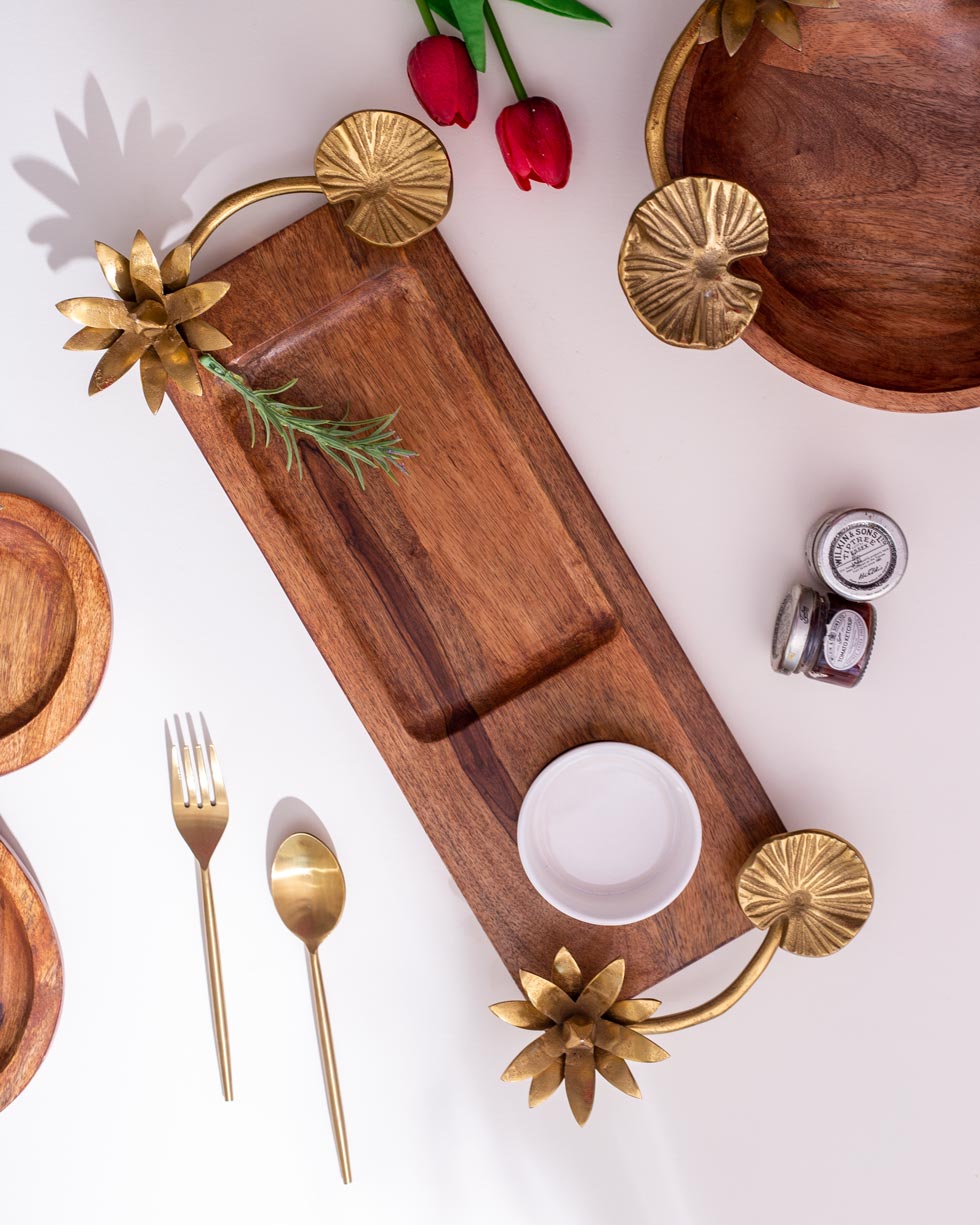 Rustic wooden serving tray with elegant gold lotus flower handles and matching gold cutlery, perfect for stylish home dining experiences.