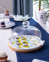 Ginkgo Cake Stand featuring a vibrant patterned base and a clear glass dome, perfect for showcasing and preserving delectable baked goods.